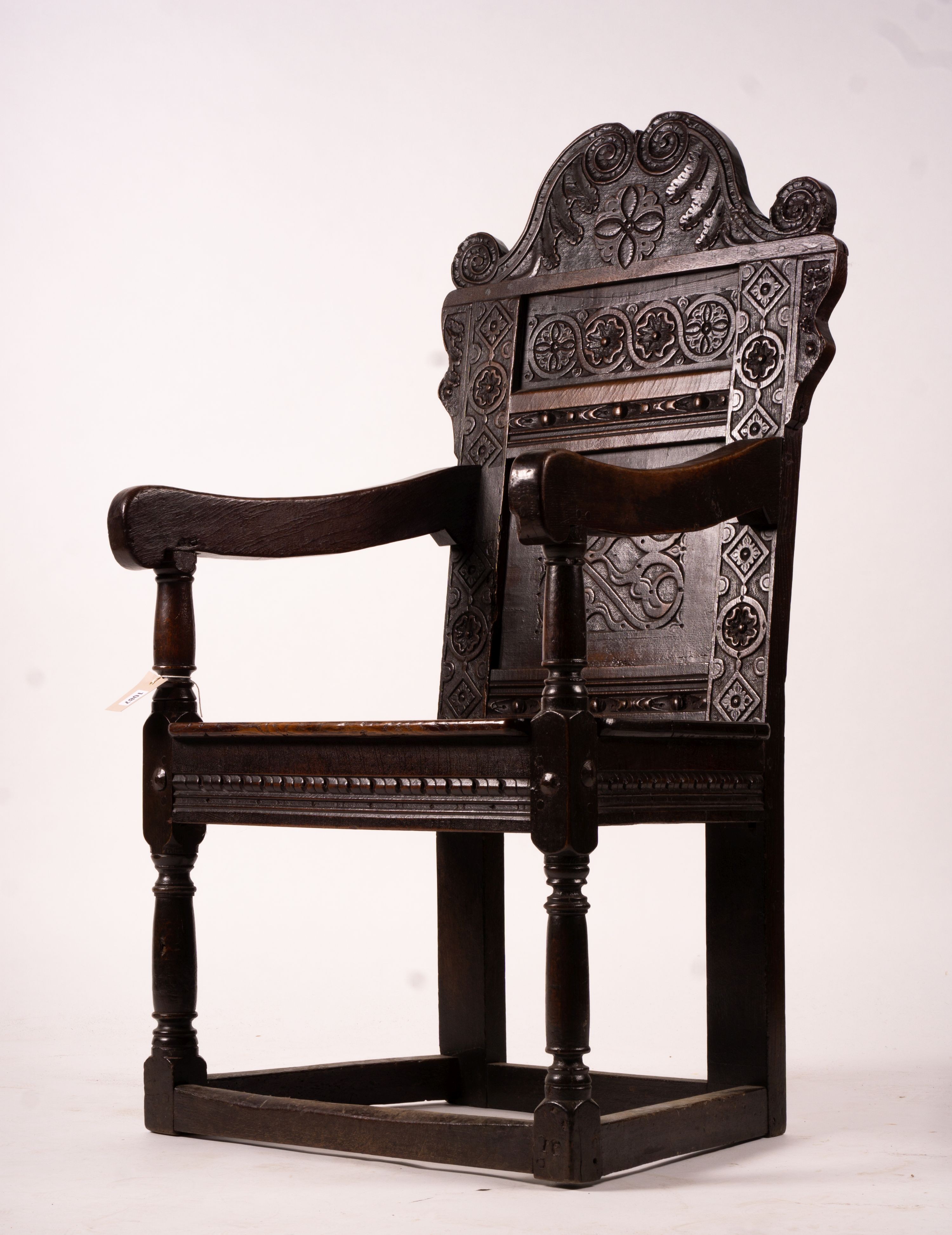 A 17th century Yorkshire area carved oak wainscot chair, width 62cm, depth 48cm, height 118cm